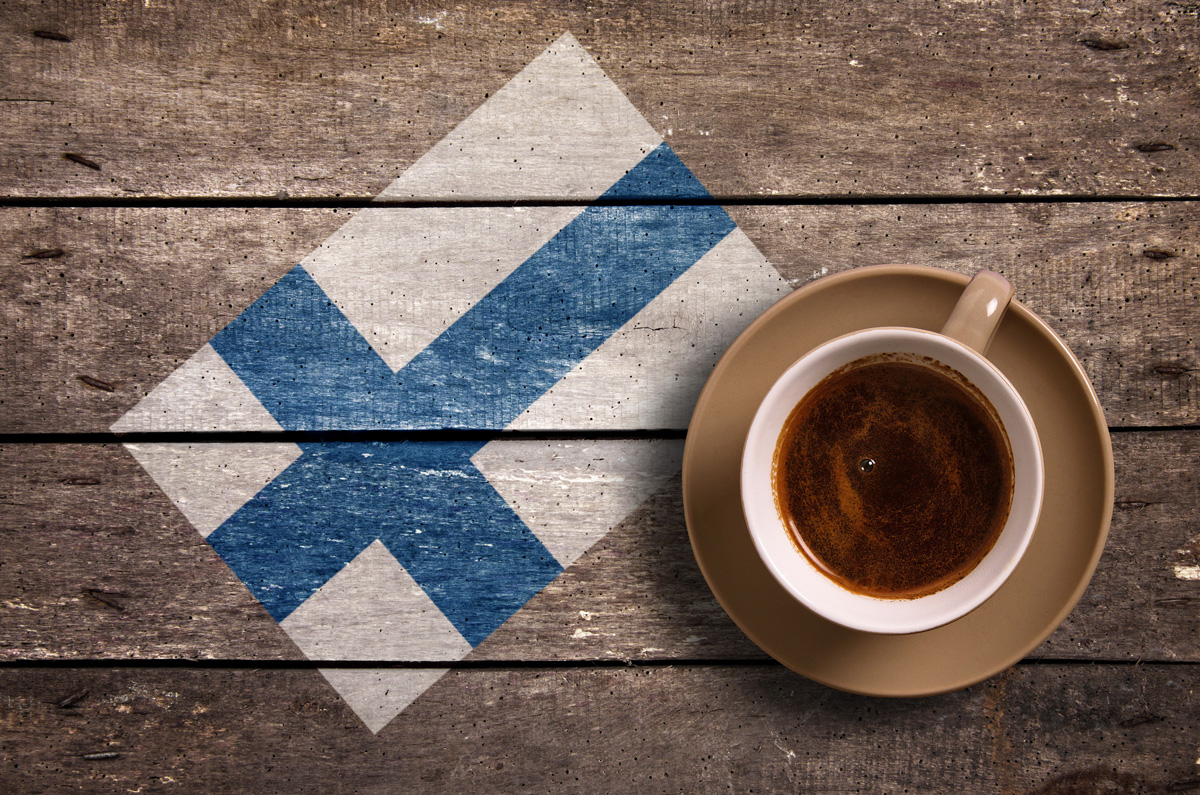 Finland flag with coffee on table. top view
