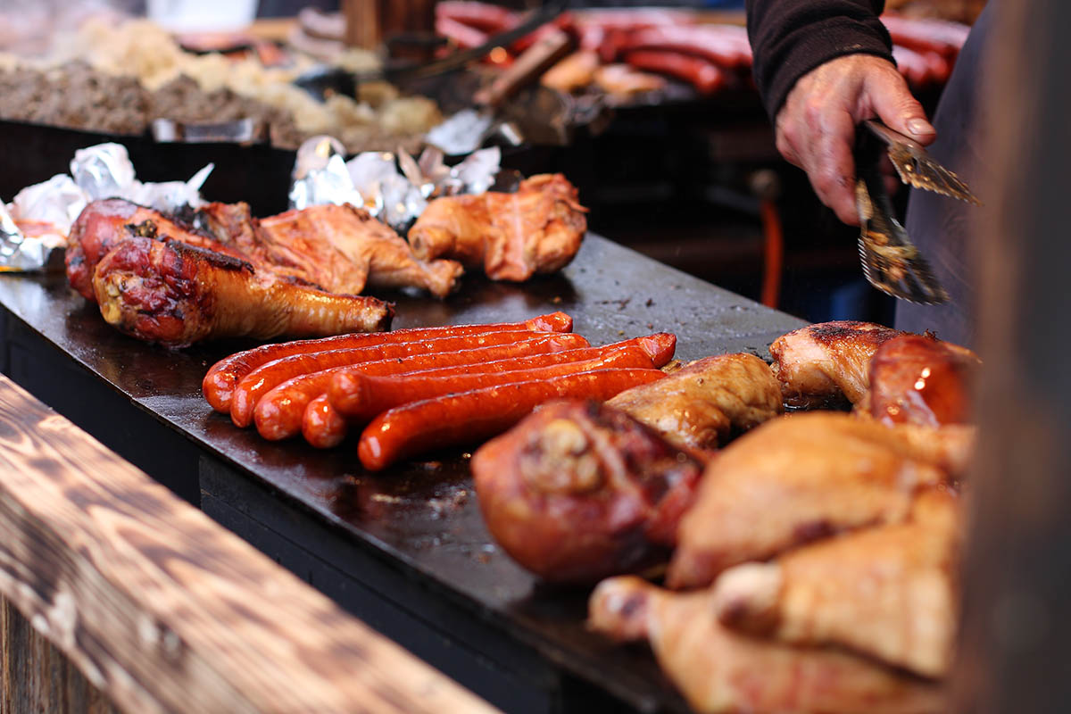 Smoked meats on the grill at Christmas market